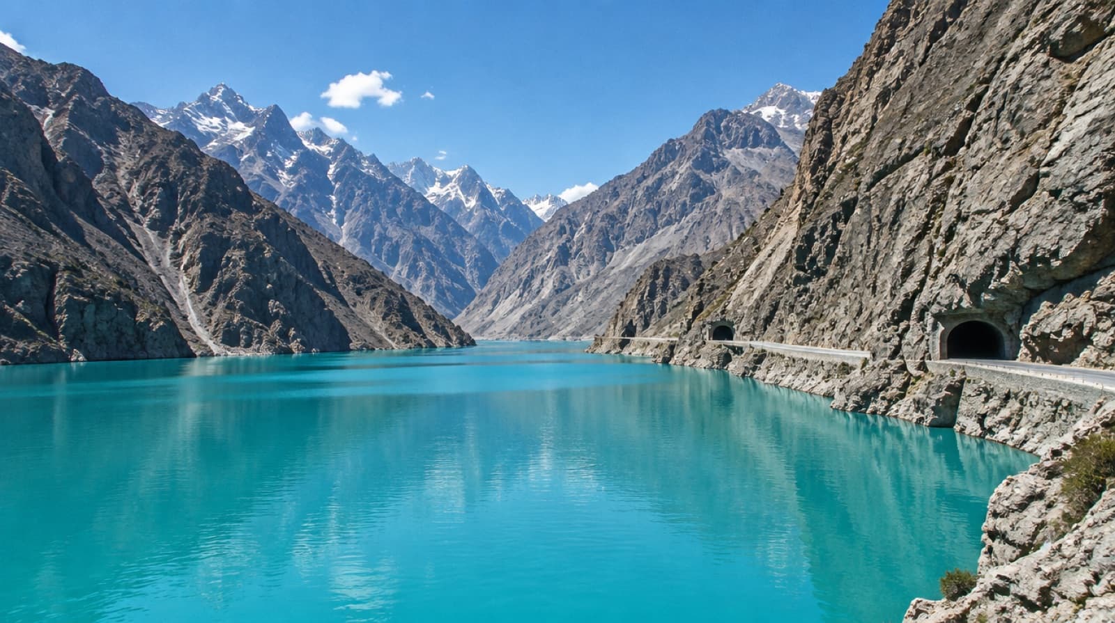 The turquoise water of Attabad Lake between grey Karakoram mountains