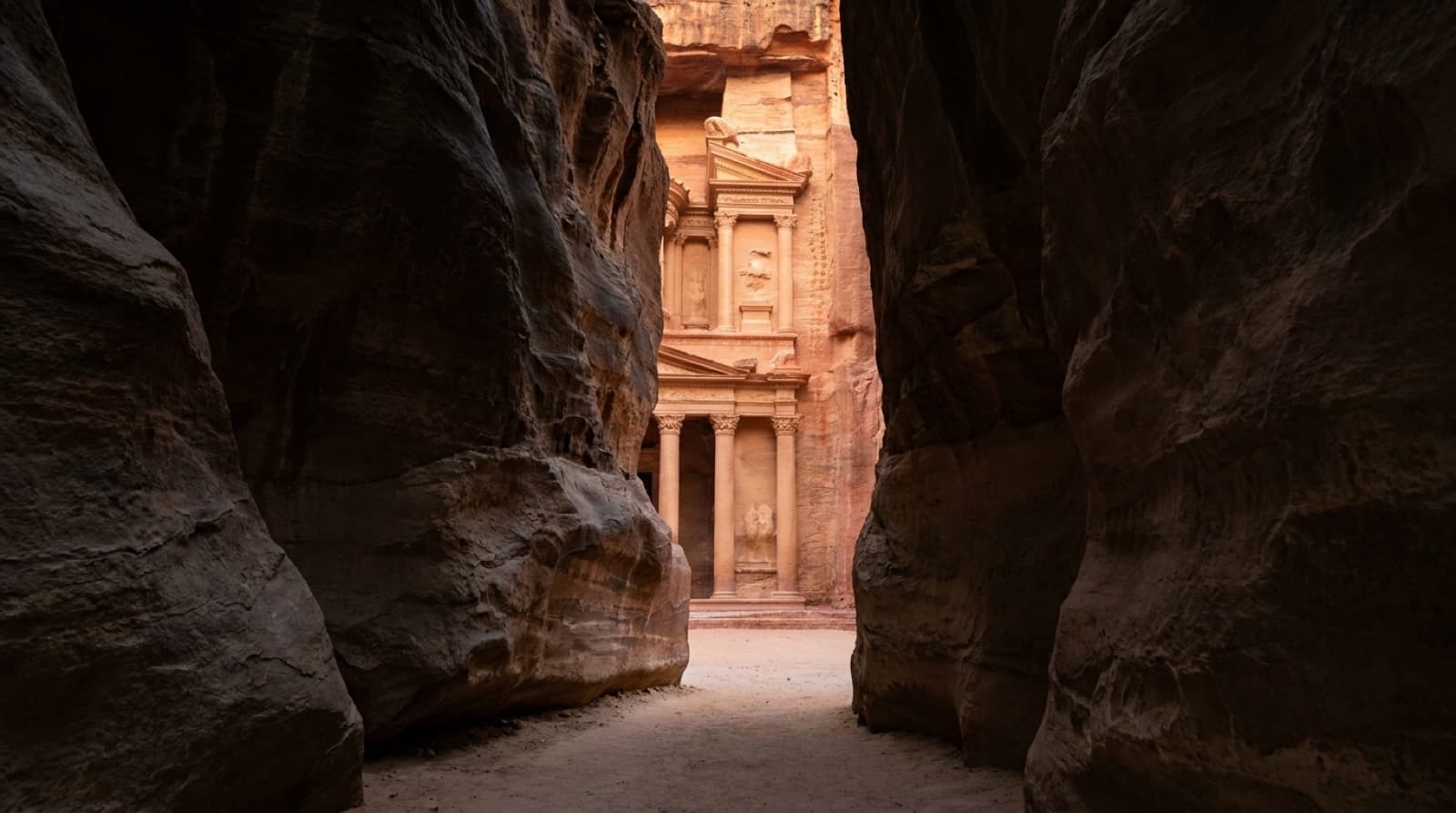 The carved sandstone facade of the Treasury at Petra, seen from the Siq