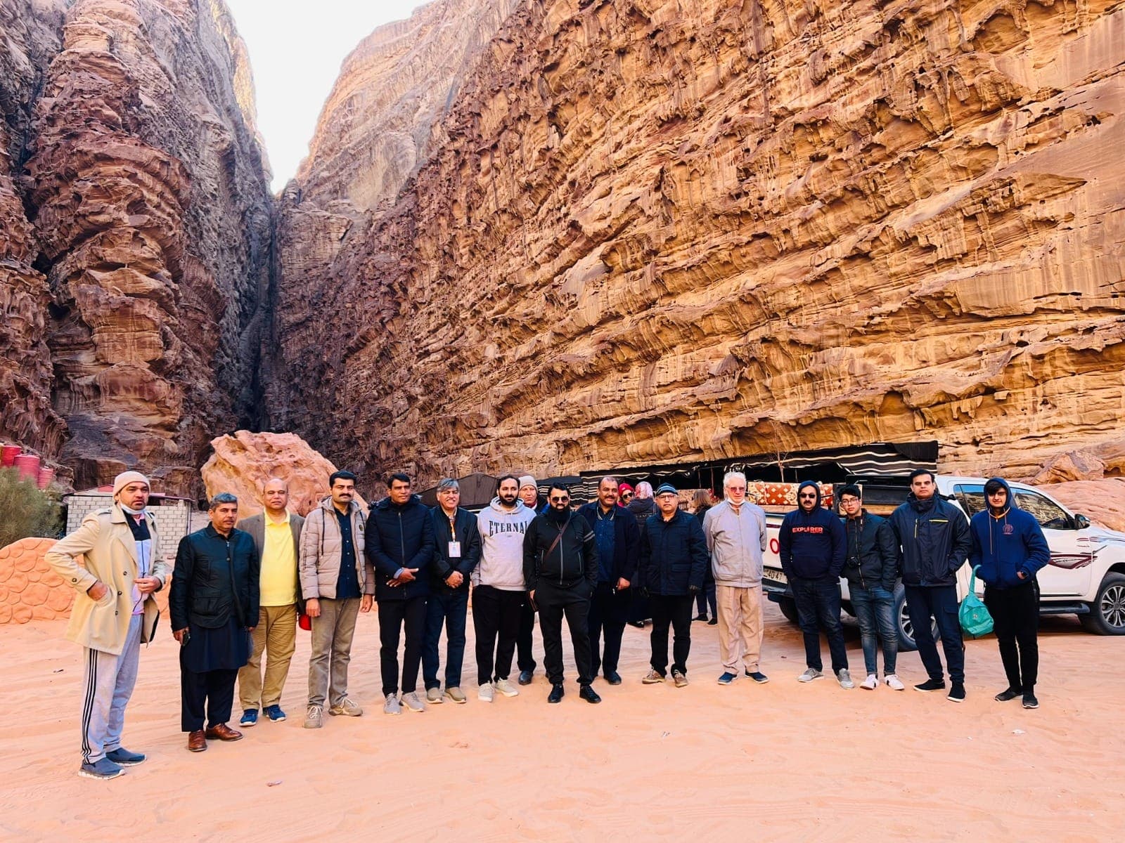 An IBEX group photographed at the mouth of a sandstone canyon in Wadi Rum beside a Bedouin camp