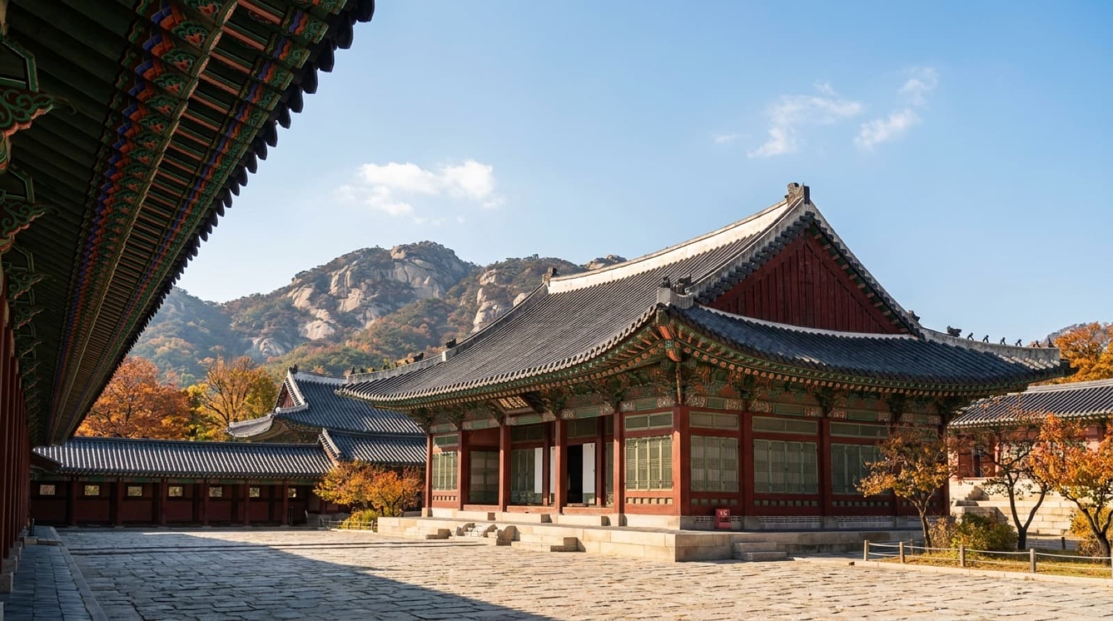 The painted eaves of Gyeongbokgung Palace in Seoul, with Bugaksan behind