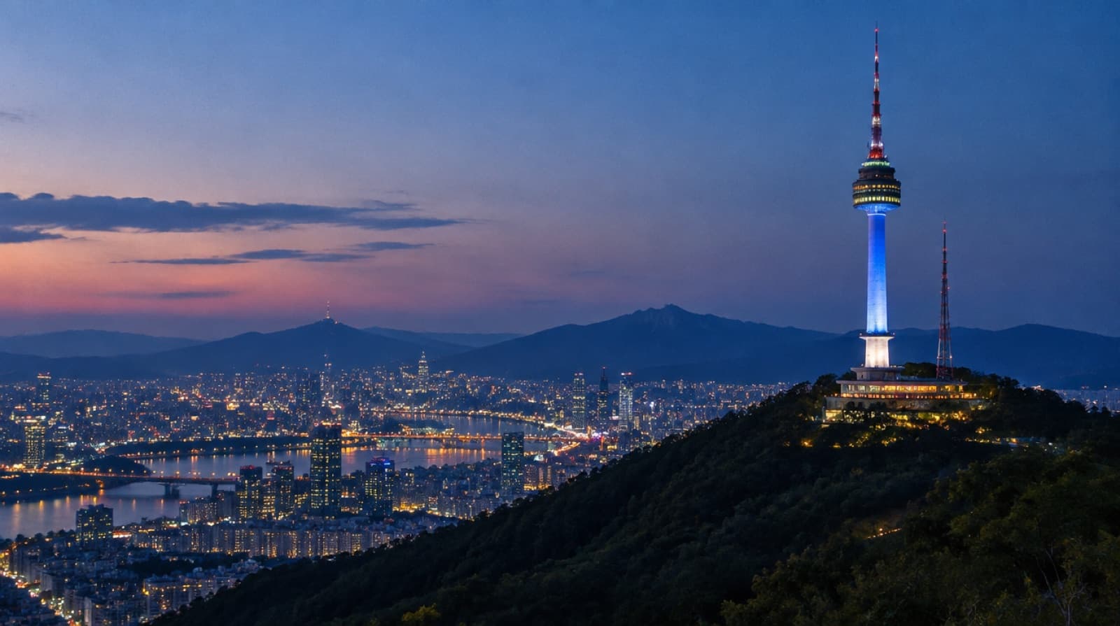 N Seoul Tower lit above the city lights at dusk
