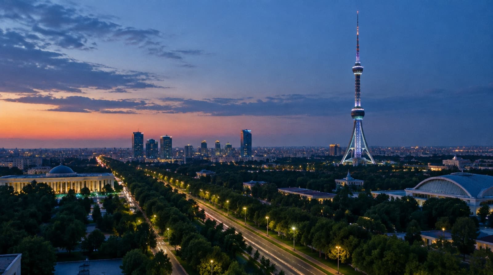 The Tashkent TV Tower lit above tree-lined avenues at dusk