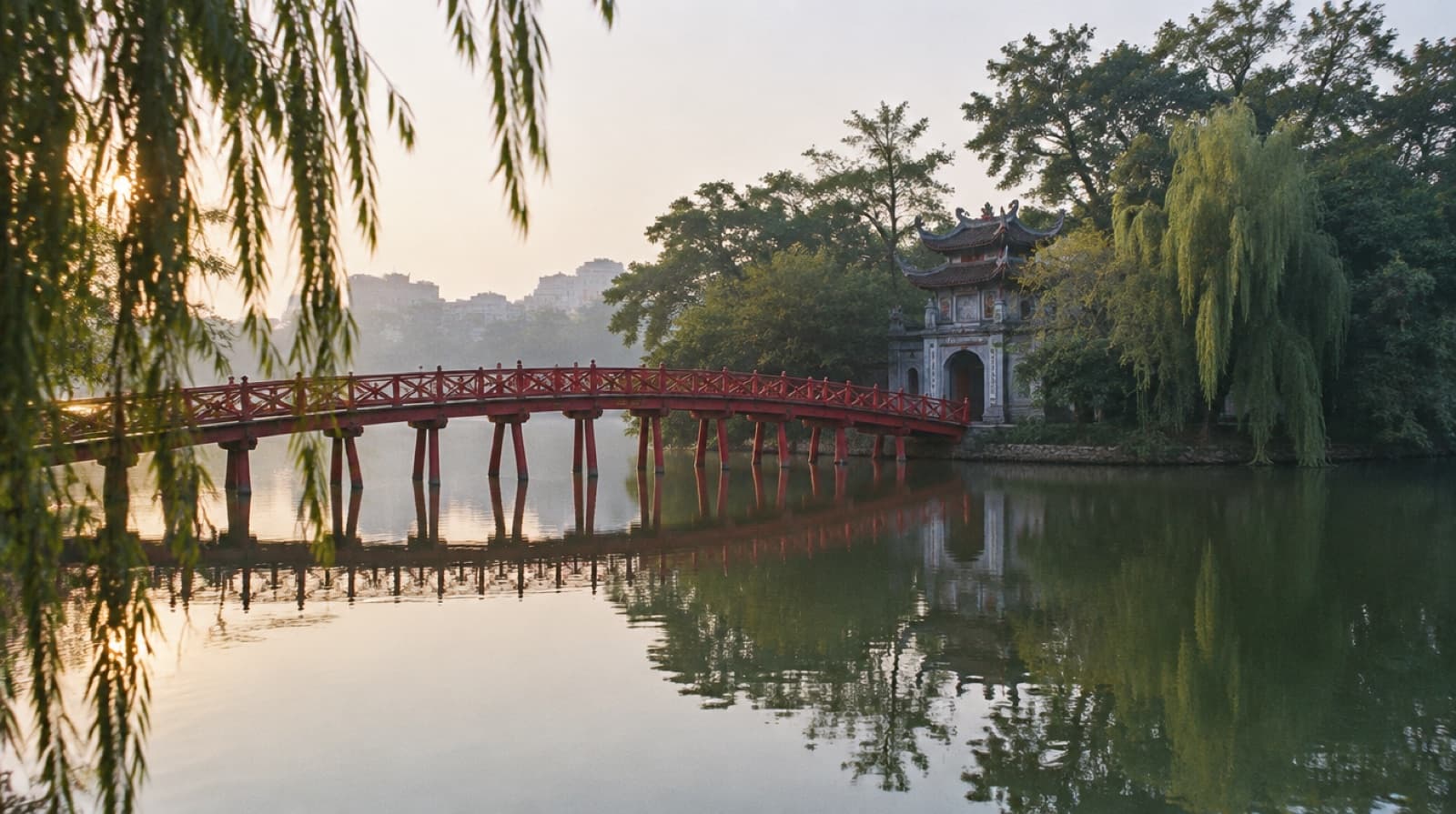 The red Huc Bridge crossing Hoan Kiem Lake to Ngoc Son Temple in Ha Noi