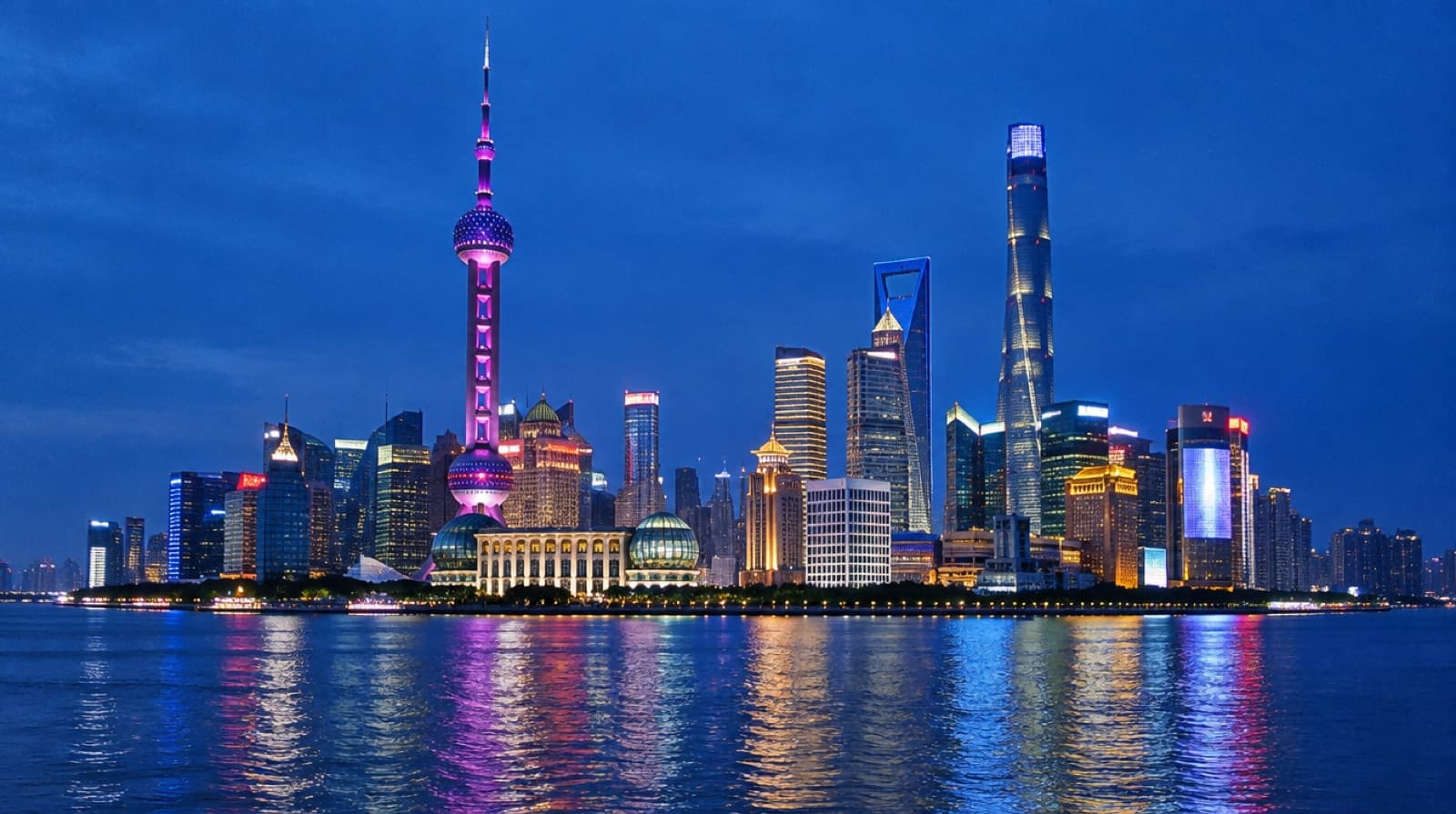 The Lujiazui skyline across the Huangpu River from the Bund in Shanghai at blue hour