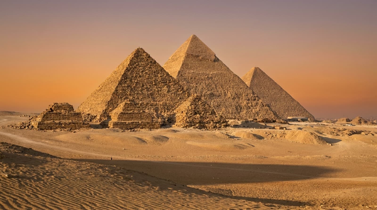 The pyramids of Giza on the desert plateau at golden hour