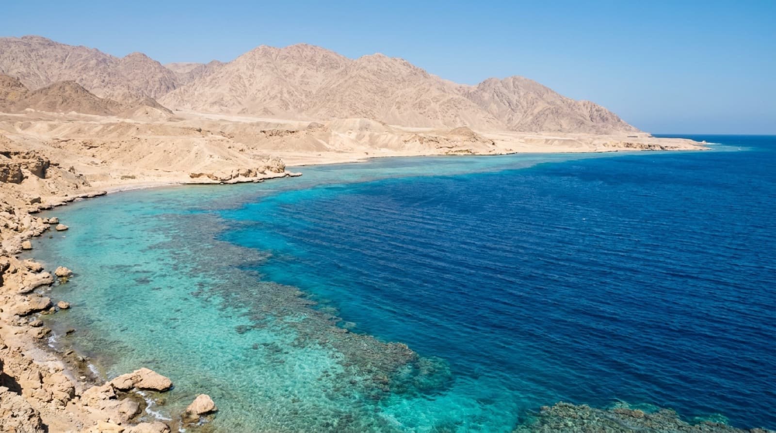 The Red Sea over a coral reef at Sharm El Sheikh, with the Sinai mountains behind